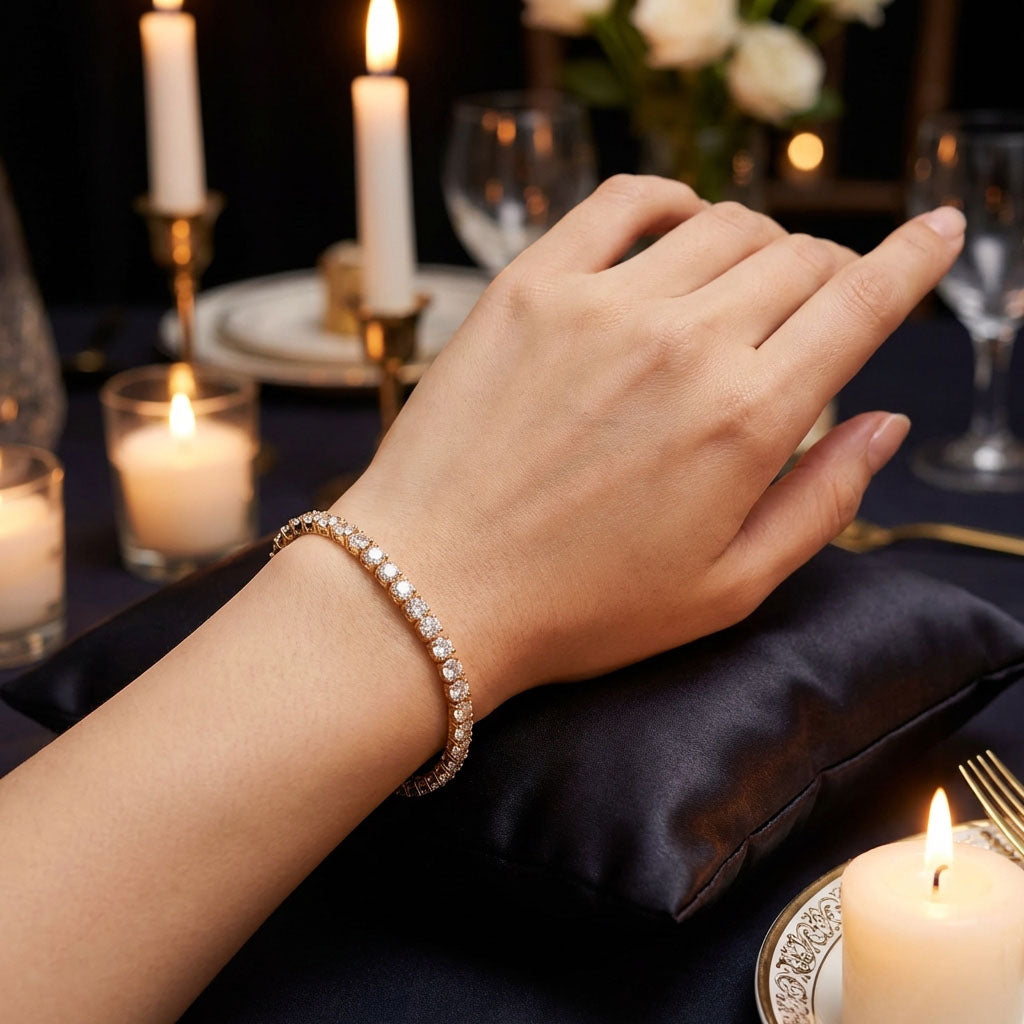 Woman wearing a sparkling gold-tone tennis bracelet at a candlelit dinner table