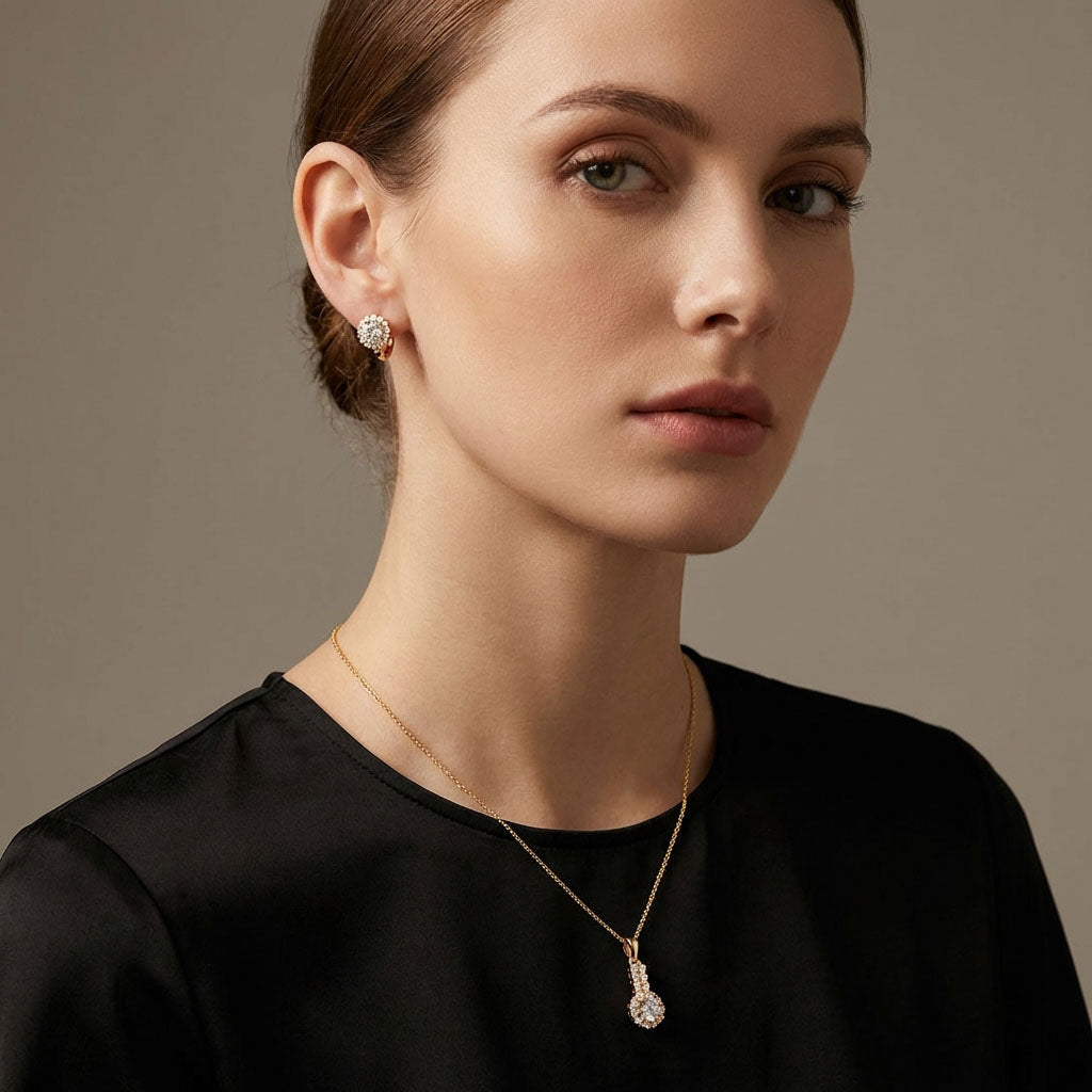 Model wearing gold-plated cubic zirconia earrings and a matching pendant on a fine chain
