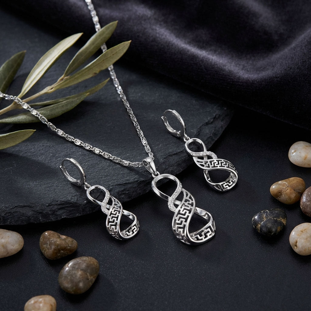 Necklace and earring set with meander infinity sign and cubic zirconia, silver tone