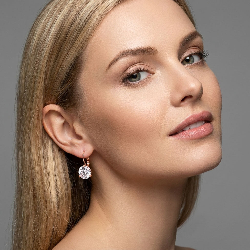 Model wearing drop earrings with a large sparkling clear cubic zirconia