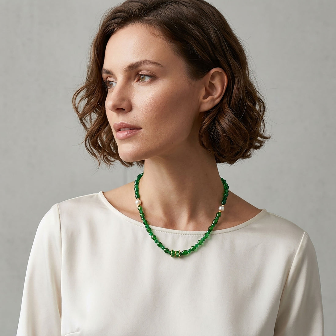 Model in a cream blouse wearing the green choker with crystals and two pearls