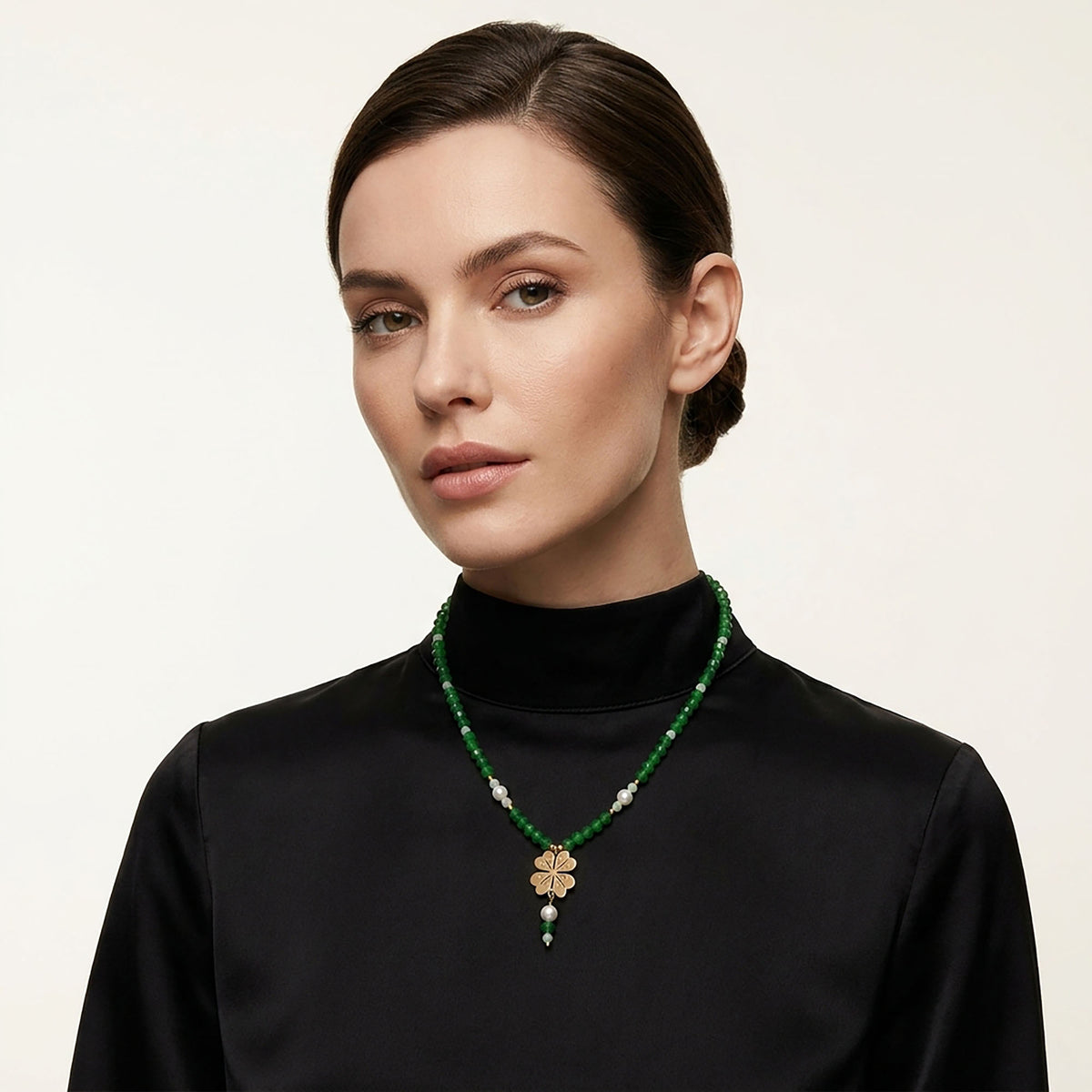 Green stone bead necklace with a gold-tone pendant