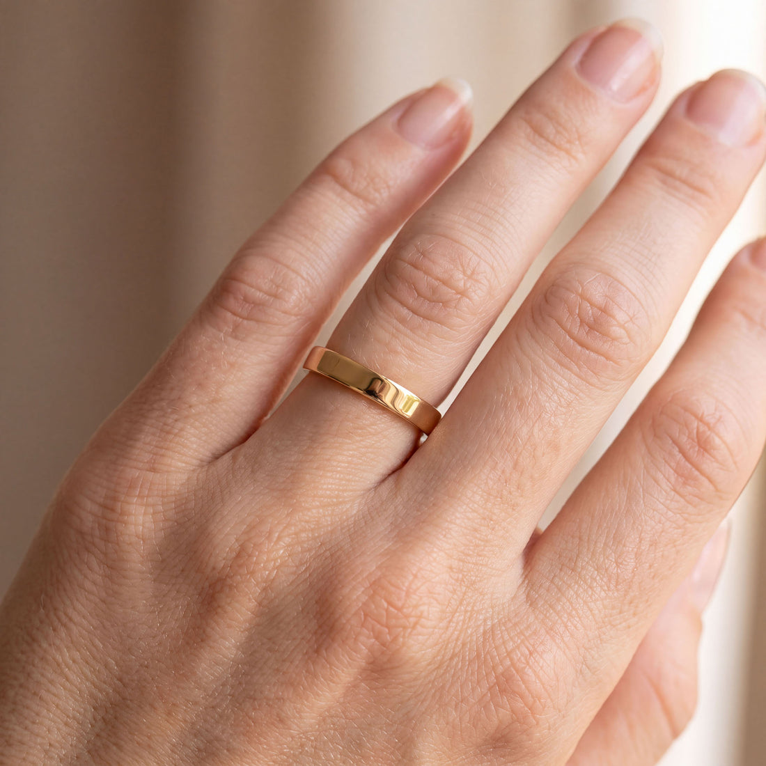 Gold-tone unisex ring without stones, with a flat smooth surface