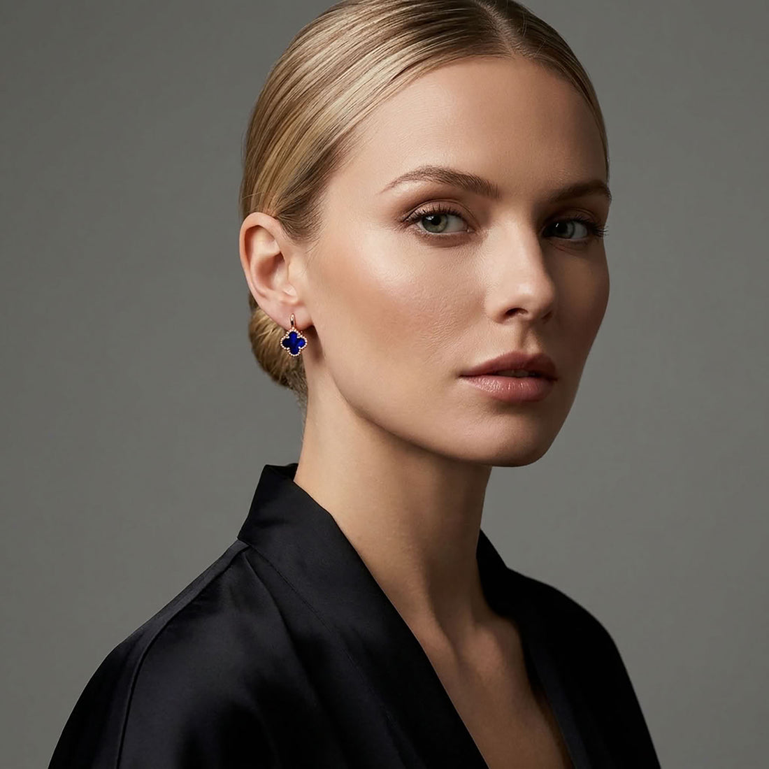 Clover earrings with dark blue enamel and a gold-tone border