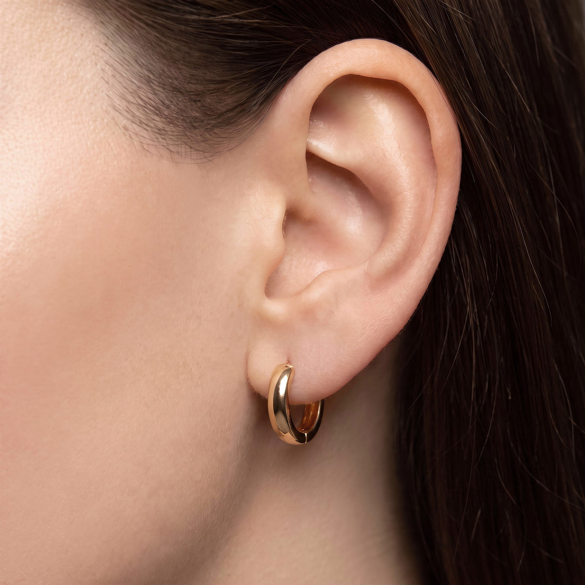 12x3 mm | Wide smooth hoop earring on the earlobe, close-up