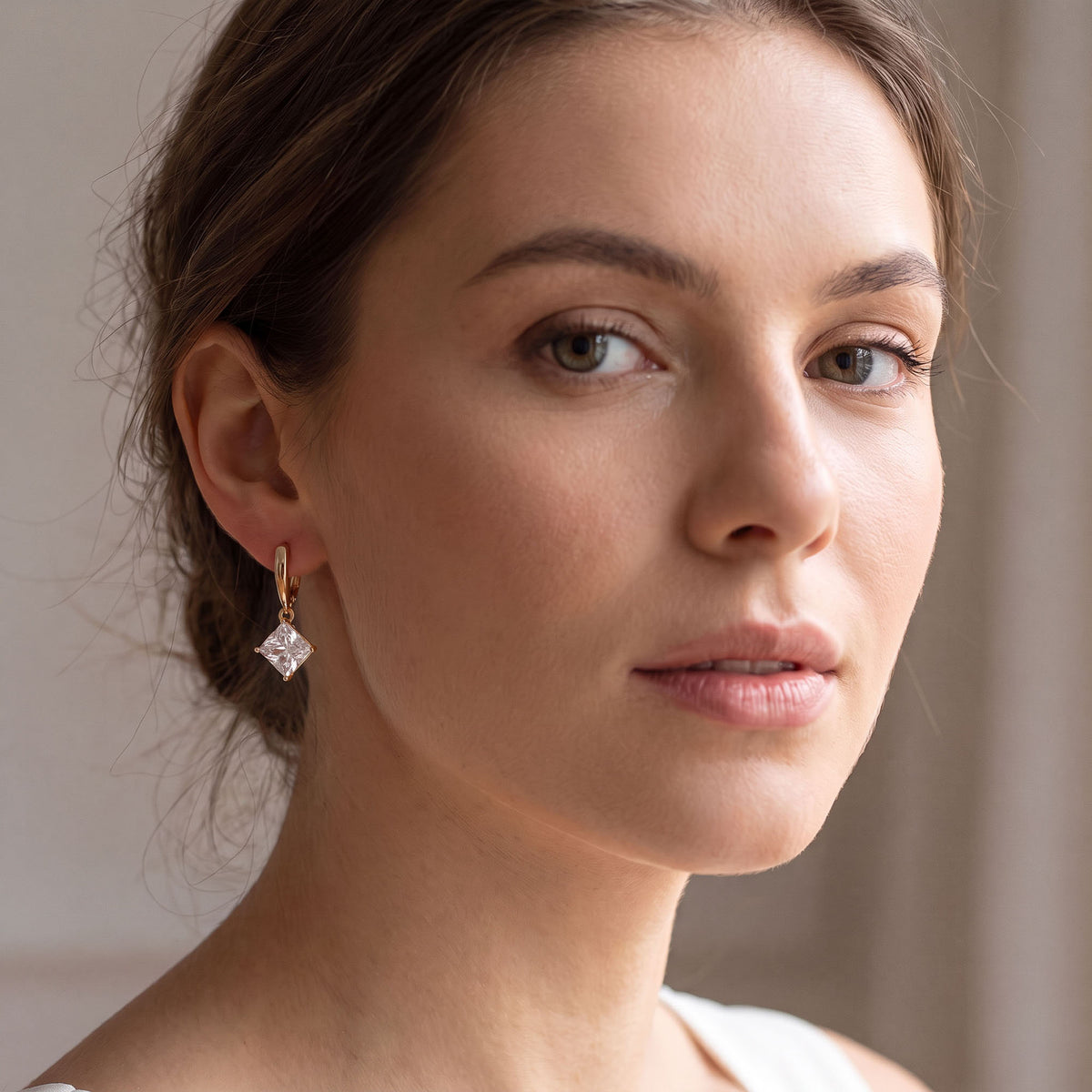 Woman with hair up wearing a rhombus cubic zirconia drop earring