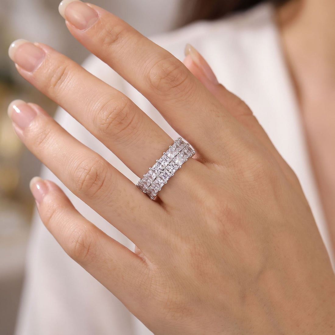 Silver | Silver-tone two-row cubic zirconia ring worn on a woman's finger