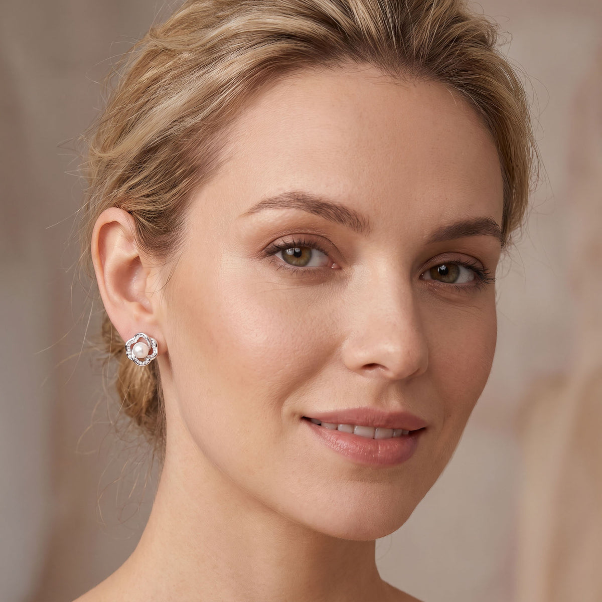 Silver | Silver-tone pearl flower earring on the ear, front view