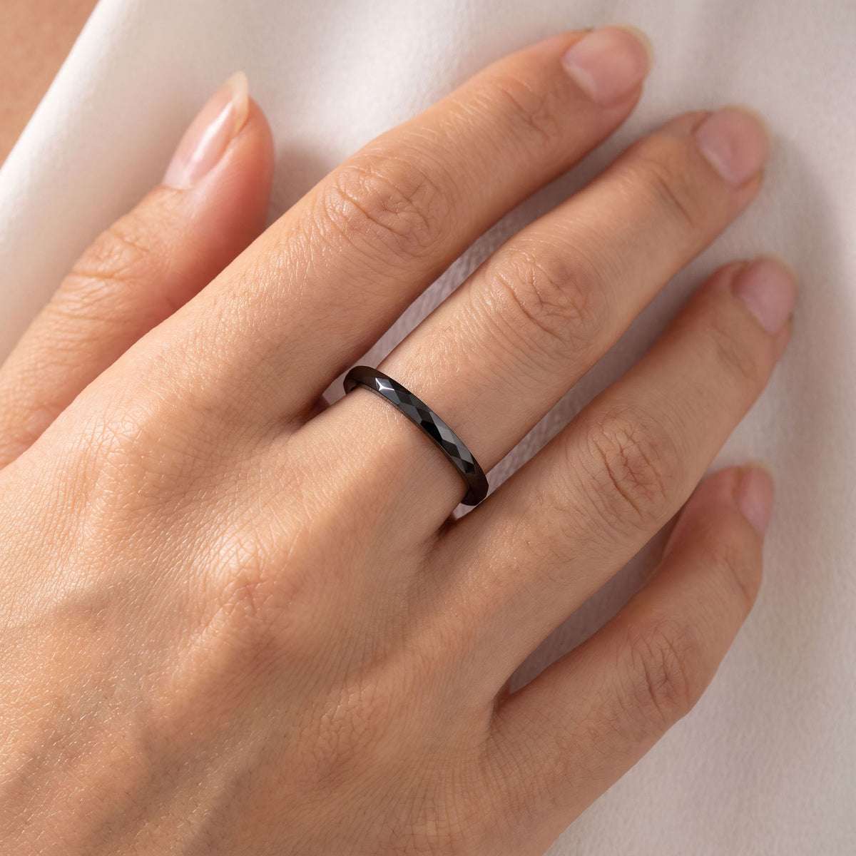 Black | Black faceted ceramic ring worn on a finger