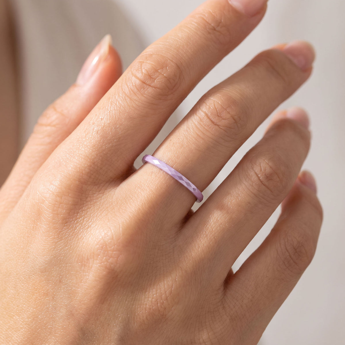 Purple | Purple faceted ceramic ring worn on a finger
