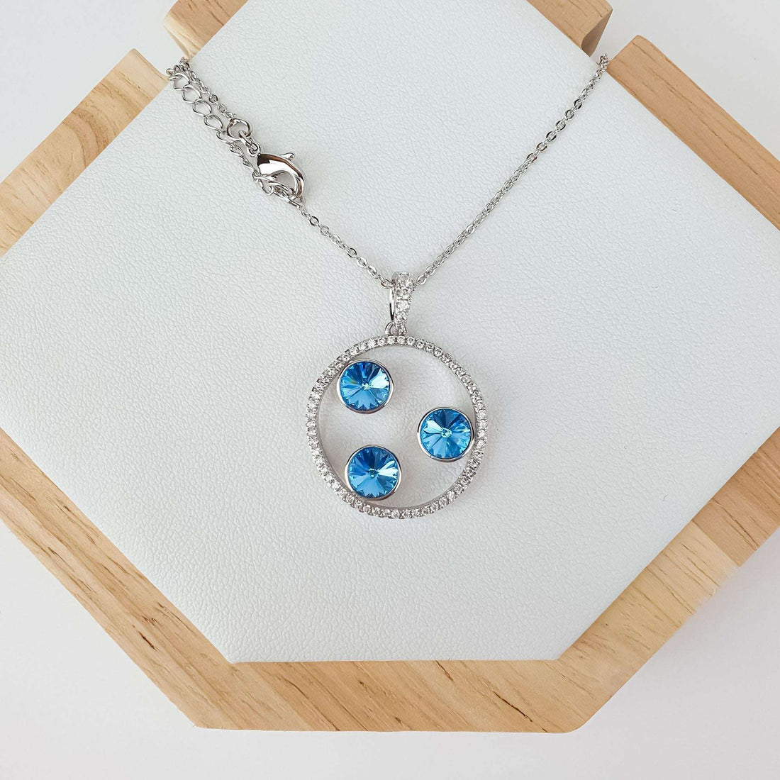 Blue stone pendant on a pale leather stand with clasp and extension chain