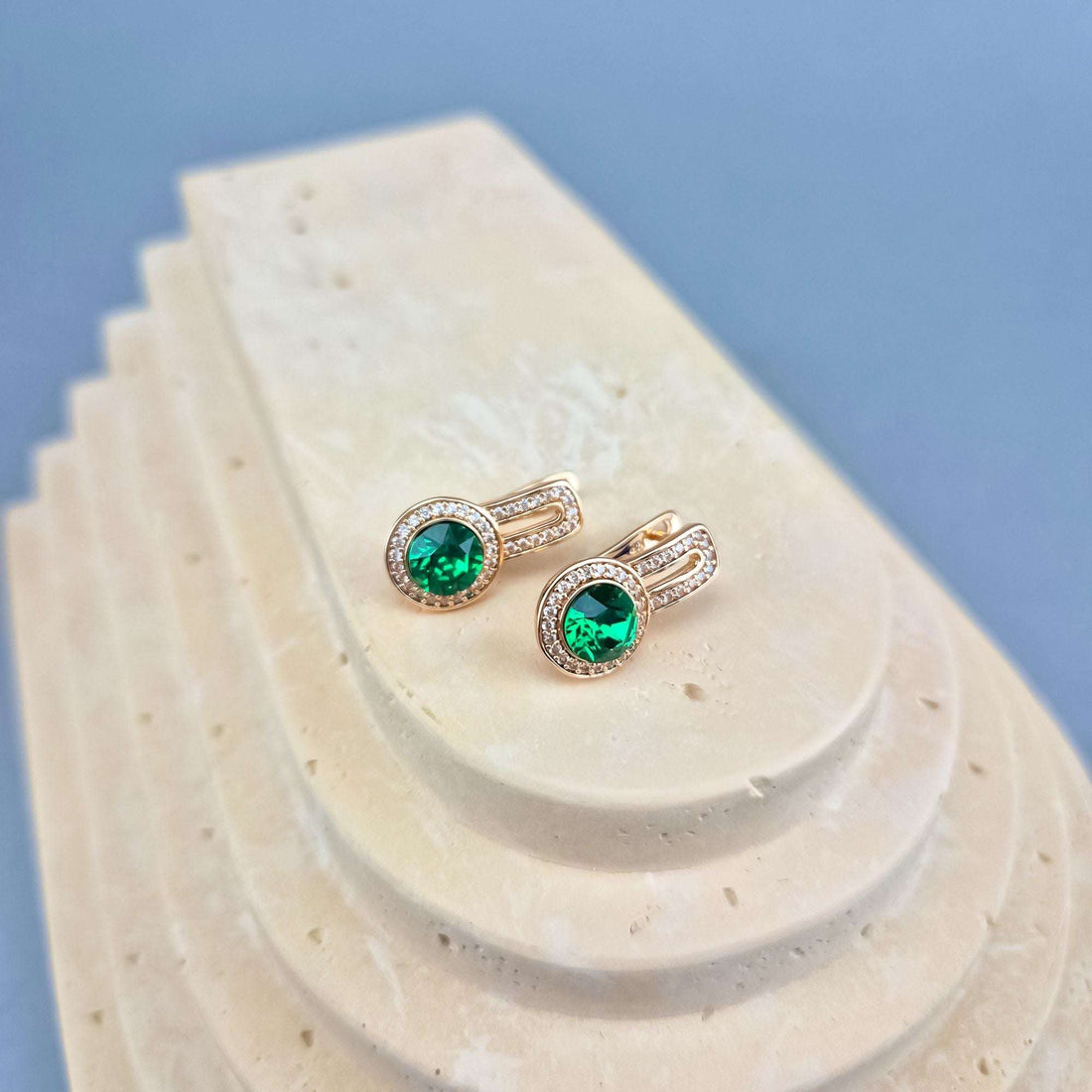 Gold-plated earrings with a green crystal, cubic zirconia border and leverback clasp