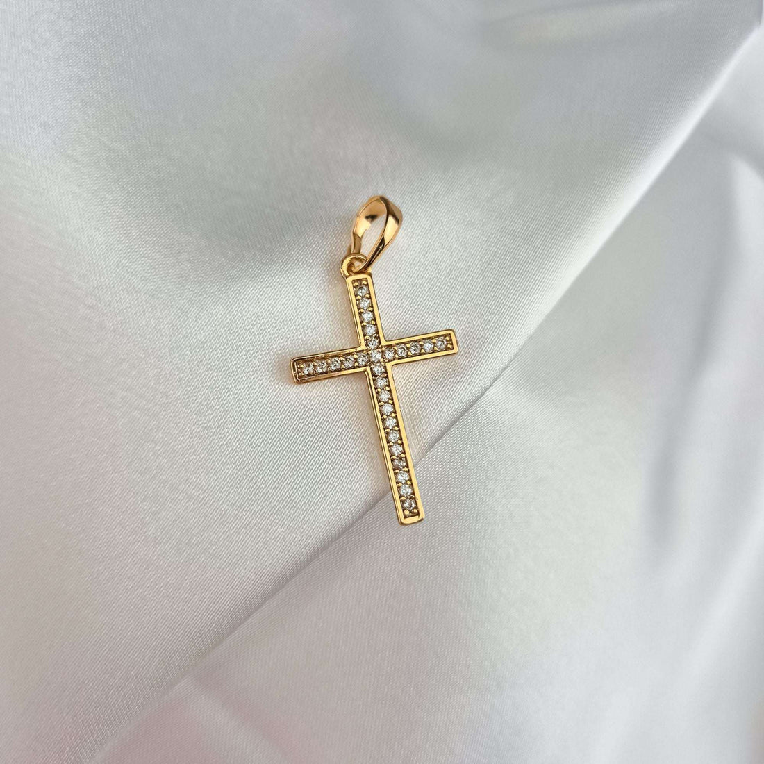 Slender cross set with crystals on soft white silk