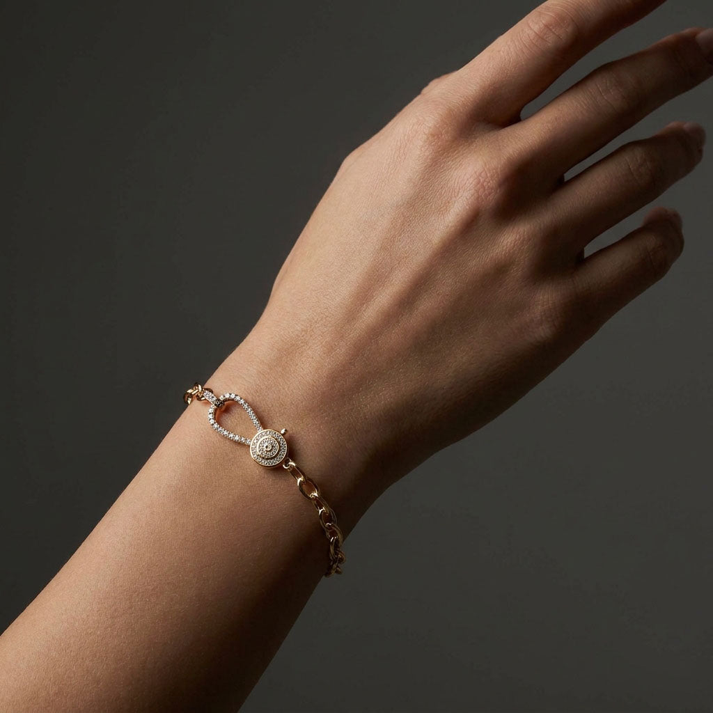 Close-up of the cubic zirconia clasp on a model's wrist, dark background
