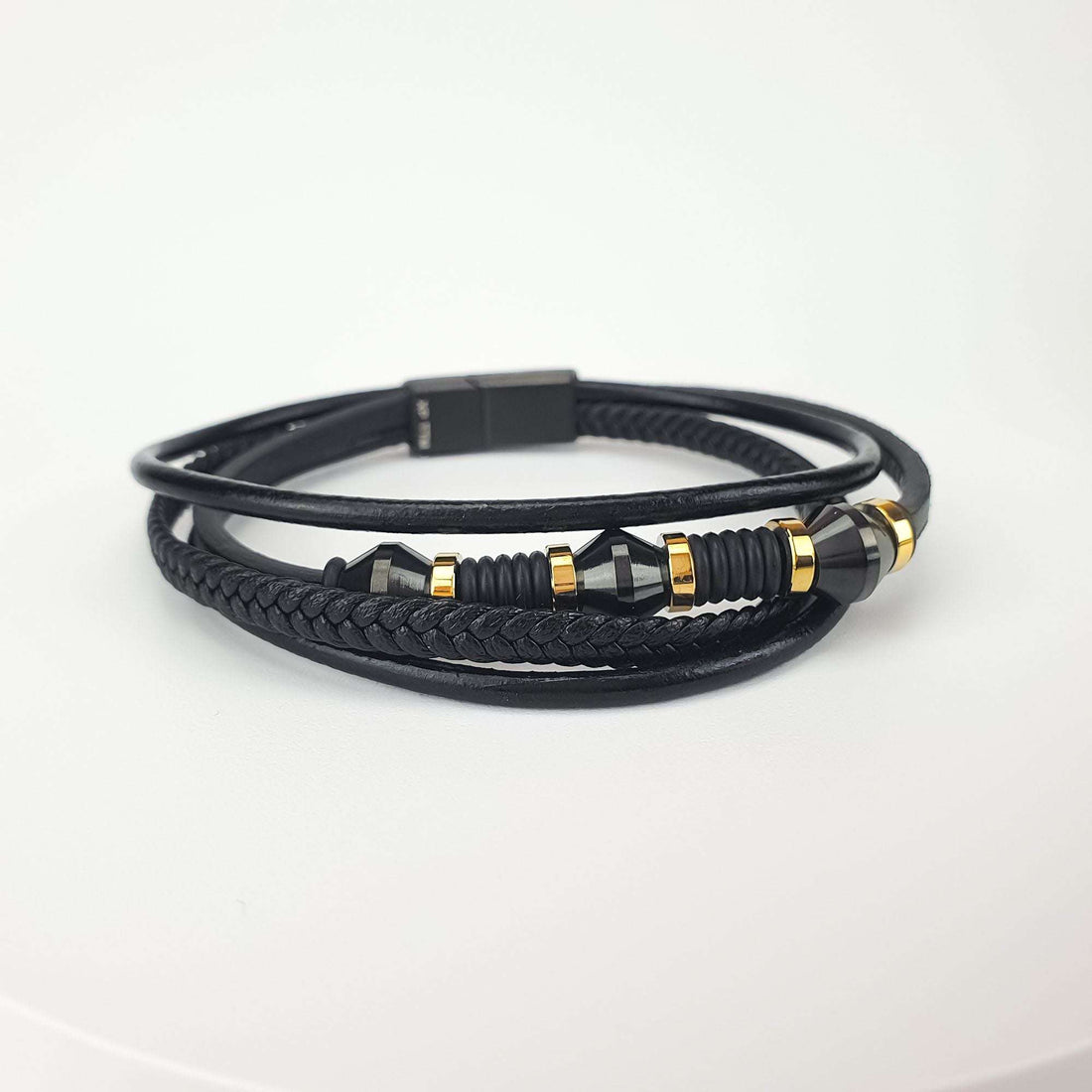 Men's layered bracelet in braided and smooth black faux leather with gold-tone steel details