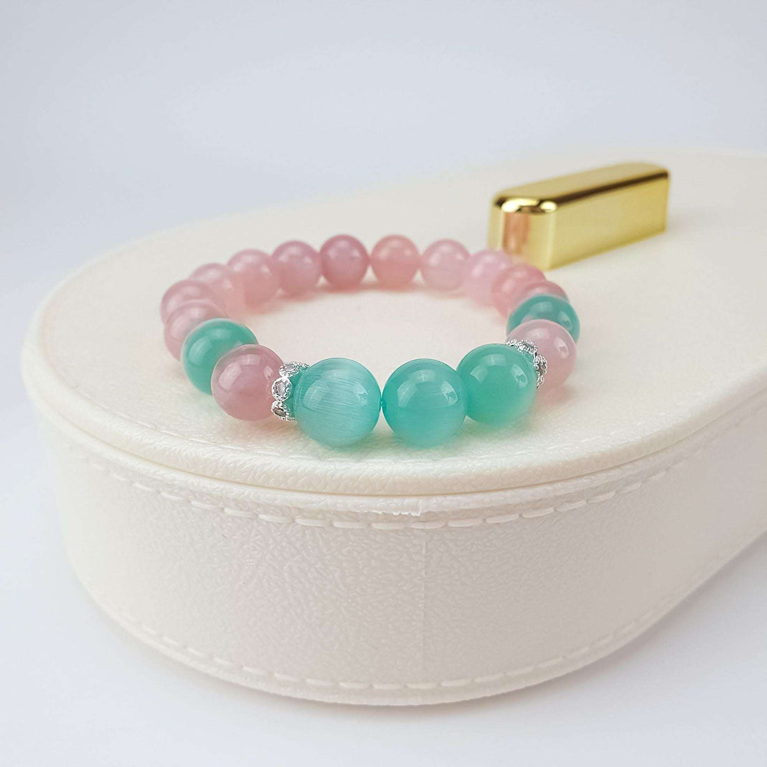 Pink and turquoise bead bracelet on a light box with sparkling crystal spacers