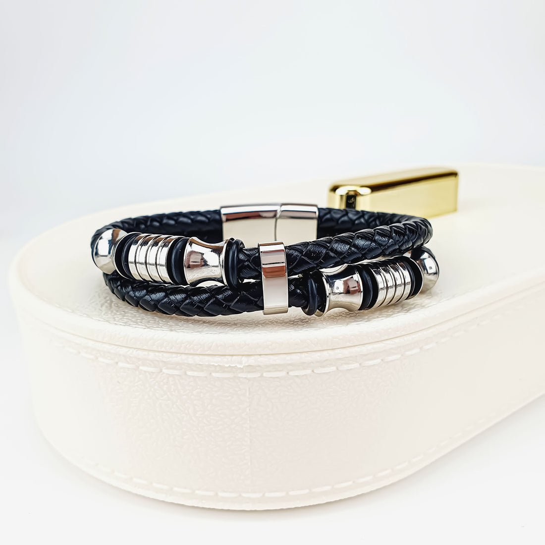 Double braided leather bracelet on a white box with a shiny steel magnetic clasp