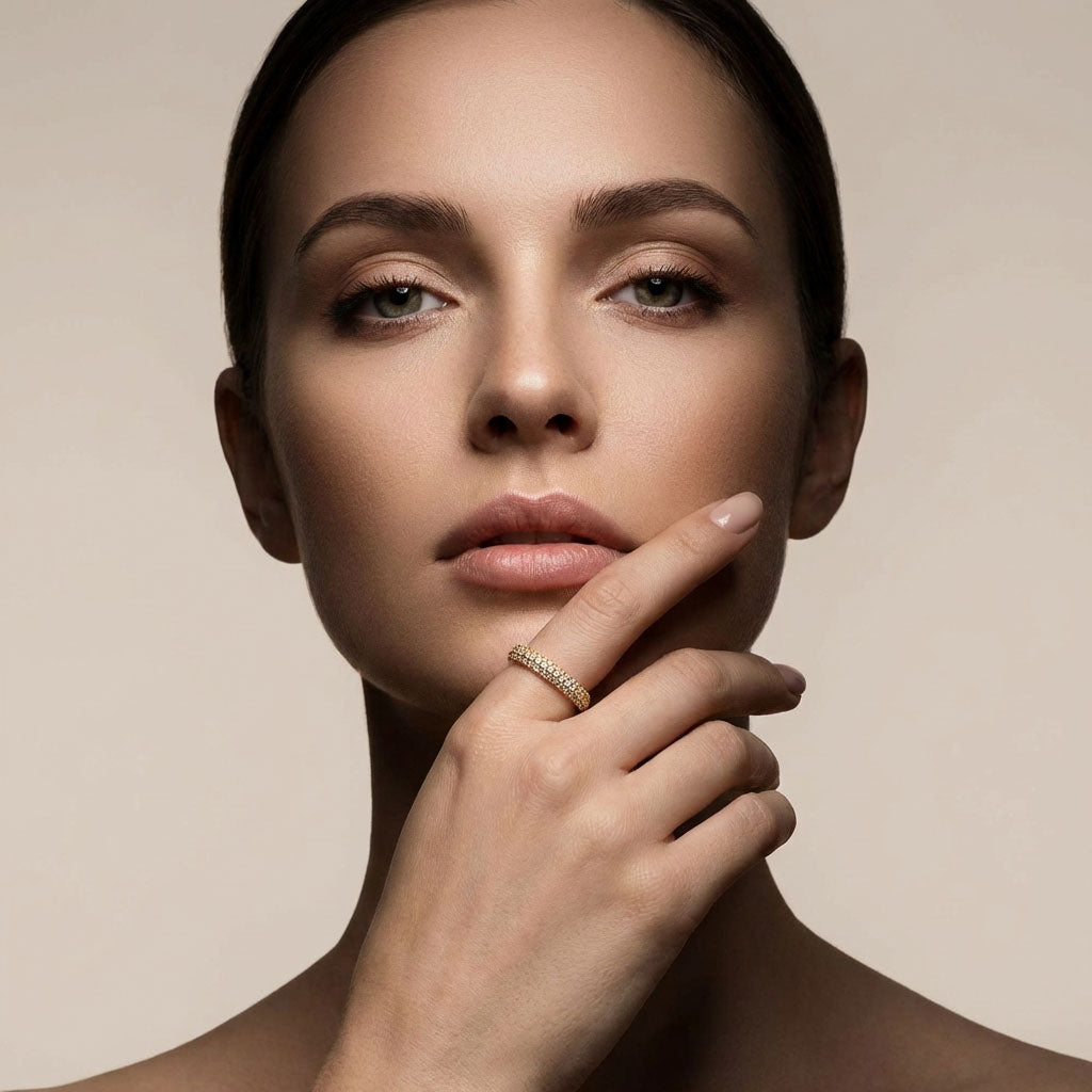 Model with her hand by her face wearing the three-row crystal ring