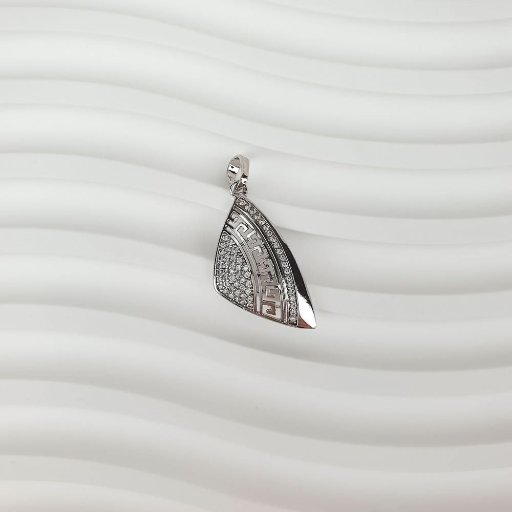 Side view of the asymmetric Greek pendant on a wavy background, sparkling stones