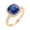 Gold-plated ring with large blue cushion stone, clear halo and stone-set band