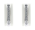 Close-up of white ceramic earrings with cubic zirconia in a silver-tone frame