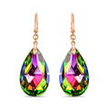 Earrings with large teardrop crystals glowing green, pink and violet, gold-plated hooks