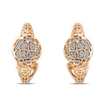 Round earrings with a cubic zirconia rose on an openwork rose gold-tone surface