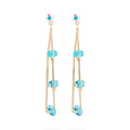 Long gold-plated earrings with three turquoise-blue crystal beads on double chains