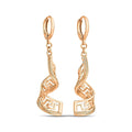 Long gold-tone earrings with a twisted ribbon and openwork Greek meander