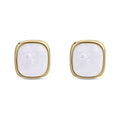 Square stud earrings with a pearlescent surface in a gold-tone frame on white