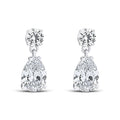 Teardrop cubic zirconia earrings with a round stone on top, on a white background