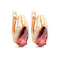 Gold-plated earrings with a large red teardrop stone and a row of clear stones