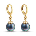 Gold-plated small hoops with dark faux pearls and a rainbow sheen on white