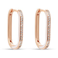 Elongated oval earrings in a rose gold tone with white enamel and cubic zirconia
