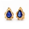 Gold-plated clip-on earrings with a deep blue pear-shaped stone and cubic zirconia