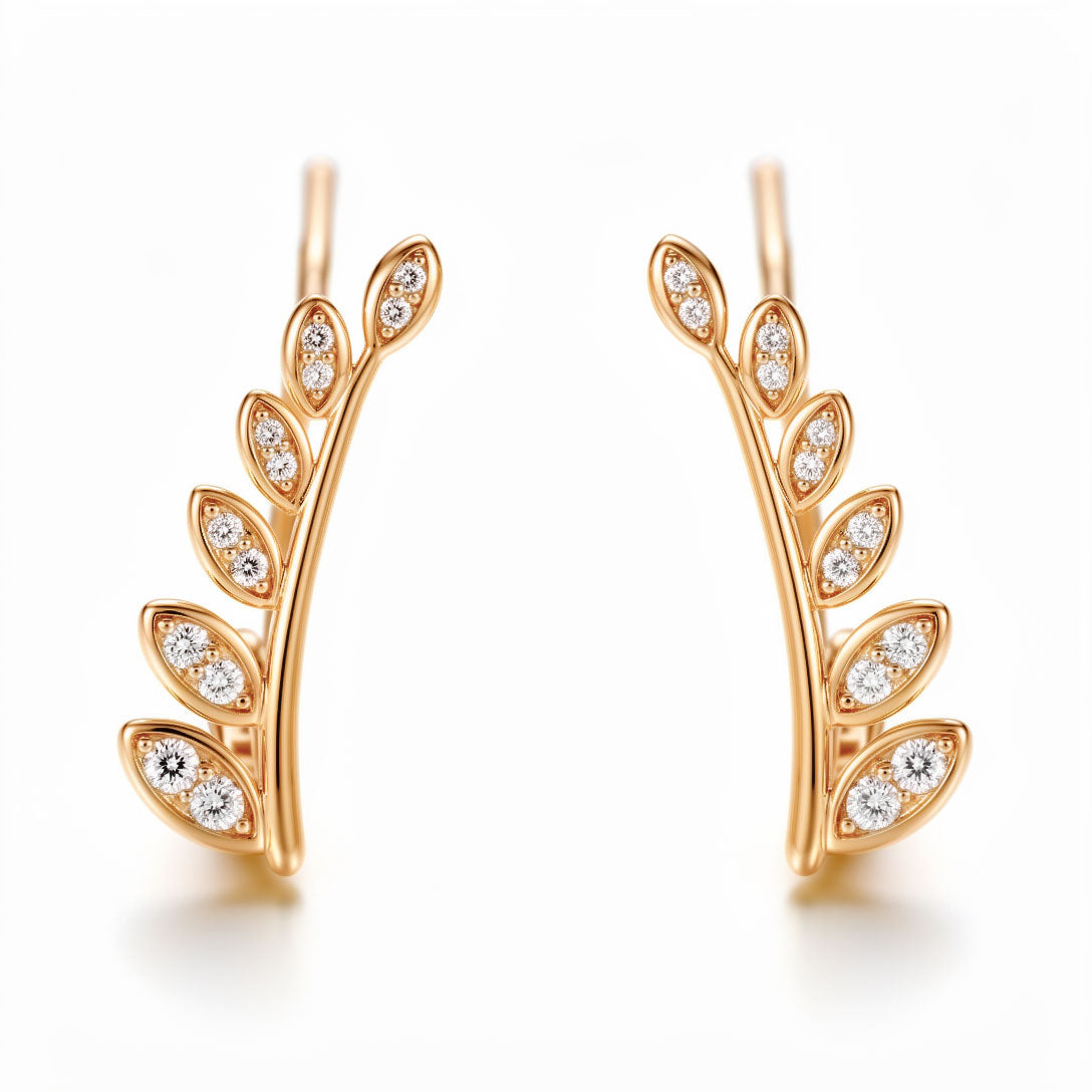 Gold-plated leaf branch ear climbers with white cubic zirconia on a white background