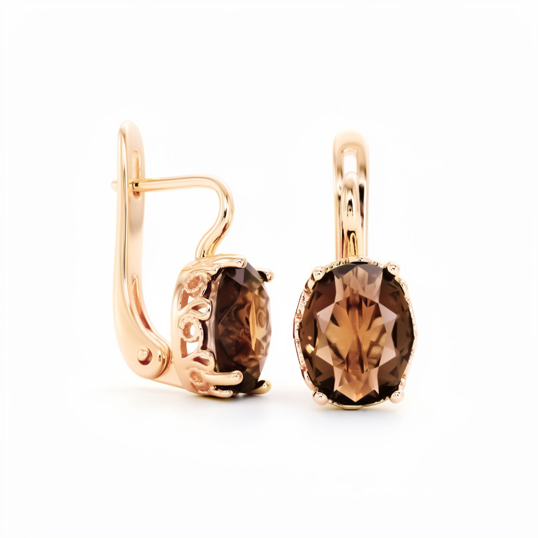 Earrings with an oval faceted coffee-coloured cubic zirconia in an openwork frame