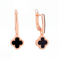 Long earrings with a black enamel clover in a beaded gold-tone rim, leverback clasp