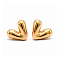 Puffy heart stud earrings with a mirror-smooth gold-tone finish on white