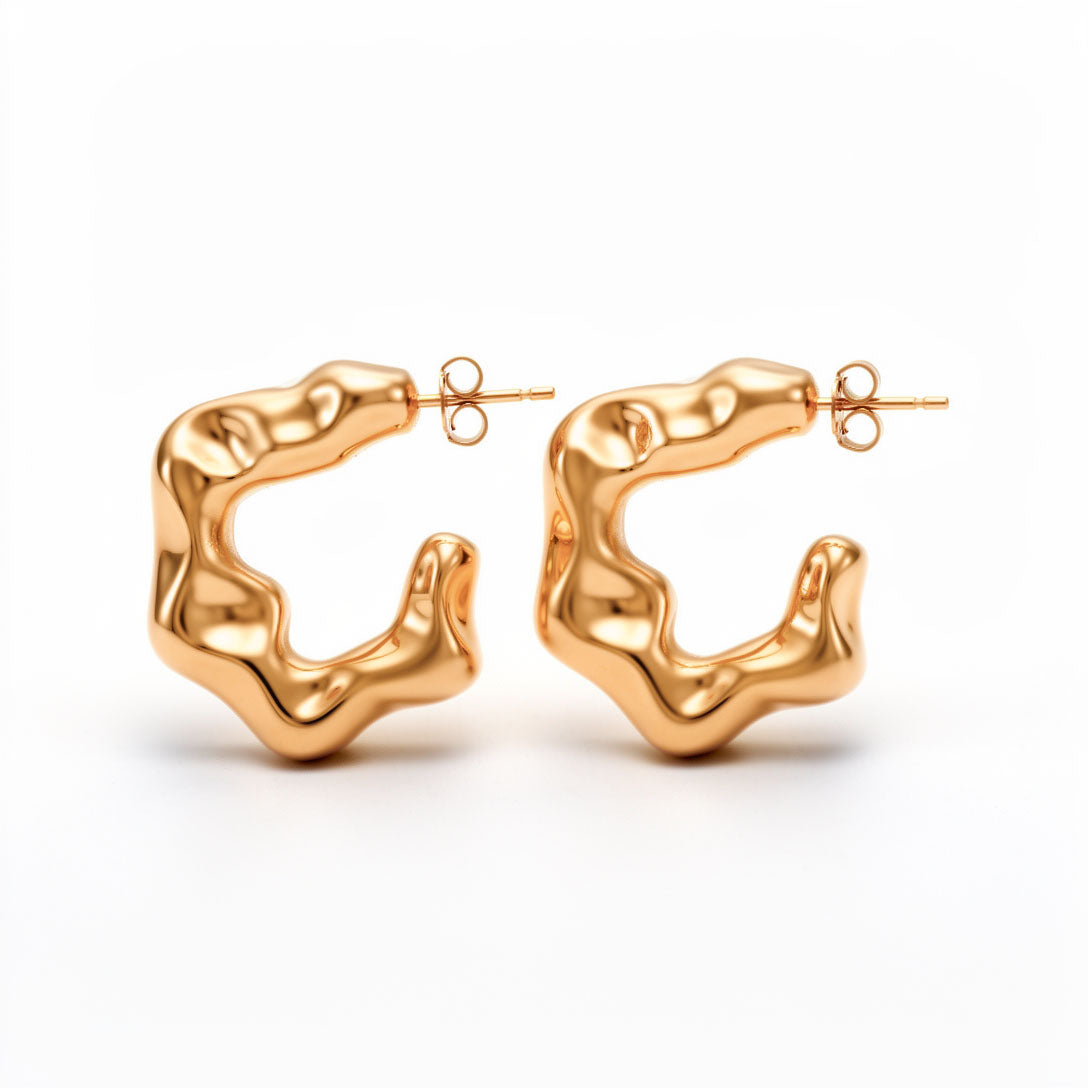 Wavy abstract half-hoop earrings with a mirror-bright gold-tone finish and stud posts