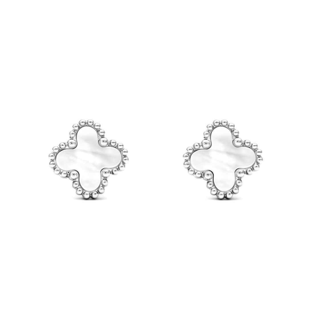 White four-leaf clover studs with a silver-tone beaded rim on a white background