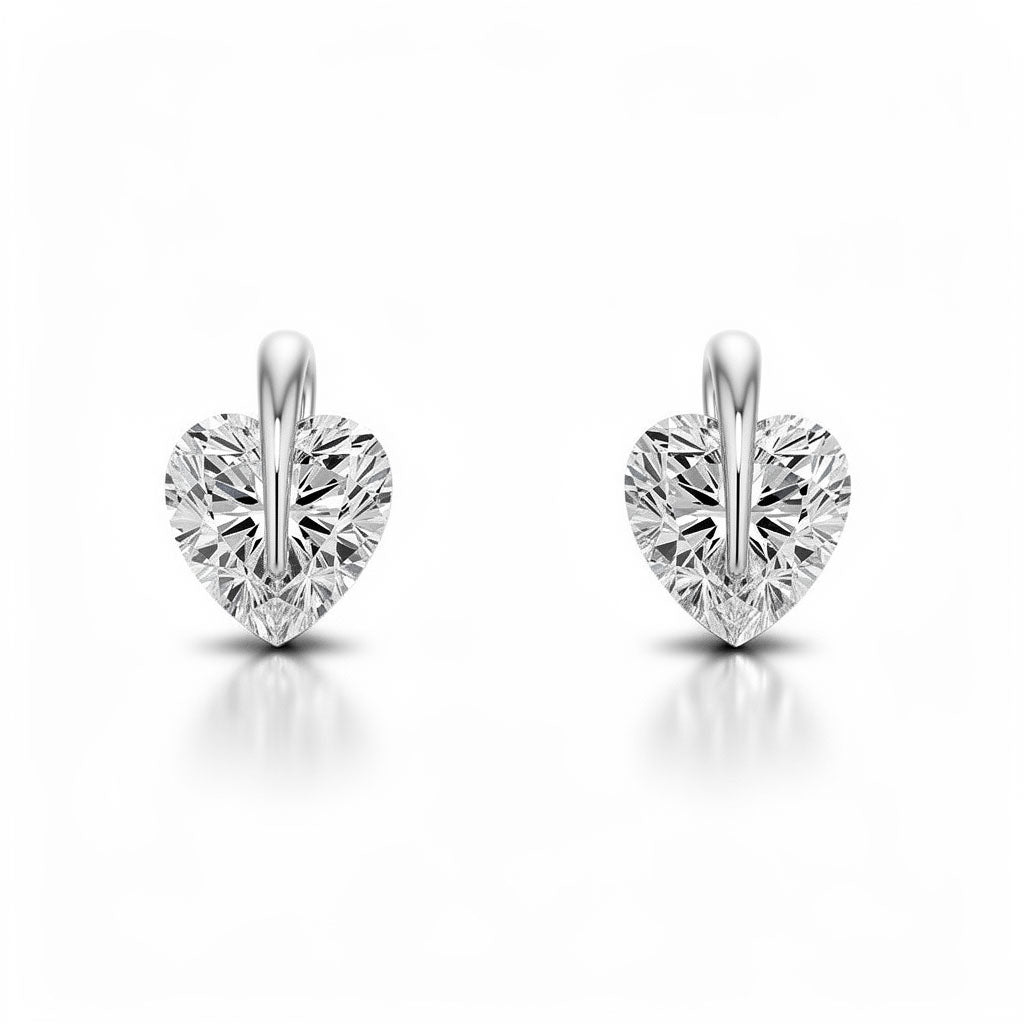 Clear heart-shaped cubic zirconia studs in silver-tone settings on a white background