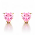 Pink heart cubic zirconia studs in gold-tone settings, close-up on a light background