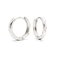 Pair of star-engraved hoop earrings with platinum plating on a white background