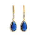 Long gold-plated earrings with a blue teardrop cubic zirconia and a white border
