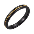 Slim black ceramic ring with a gold-tone twisted rope line in the middle