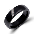 Glossy black ceramic ring with a slanted platinum-plated inlay of sparkling zirconia