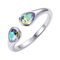 Open silver-tone ring with two multicoloured teardrop crystals on white