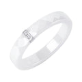 White ceramic ring with two small cubic zirconia in a silver-tone setting