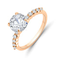 Warm gold-tone ring with a large round-cut cubic zirconia and sparkling side stones